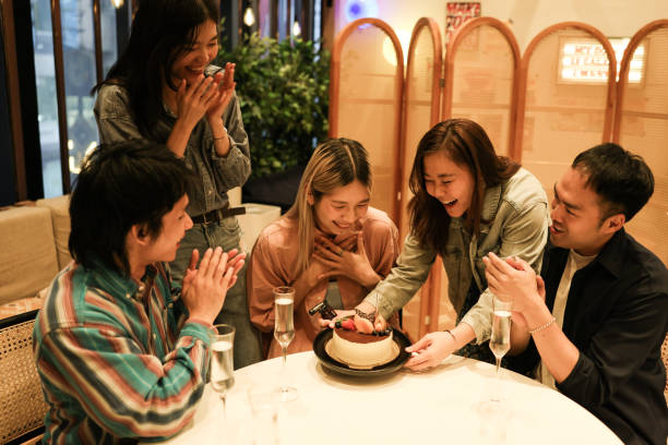 istock Young people celebrate friend's birthday with a cake 1782224280