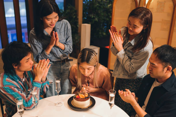 istock Young people celebrate friend's birthday with a cake 1782224608