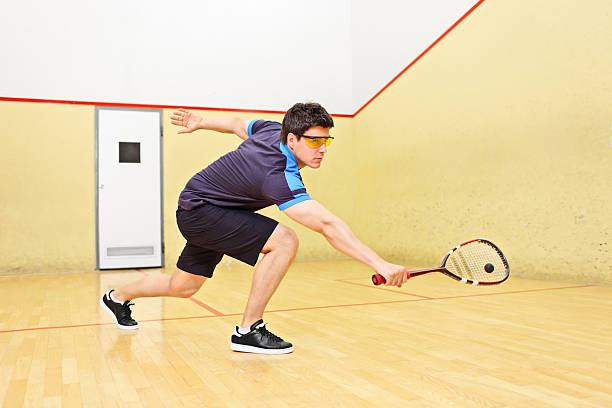 istock Squash player hitting a ball in court 178225025