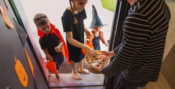 istock Children take candy from a basket. Halloween. 1782252669