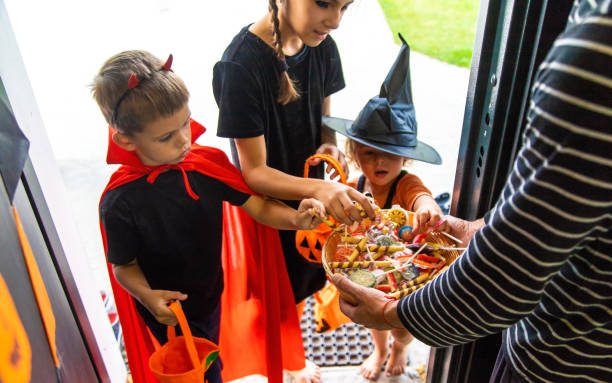 istock Children take candy from a basket. Halloween. 1782252672
