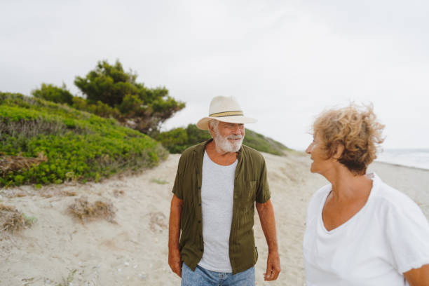 istock Senior couple in a romantic walk down the beach 1782254374