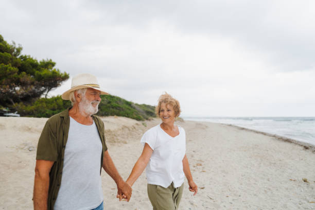 istock Senior couple in a romantic walk down the beach 1782255991