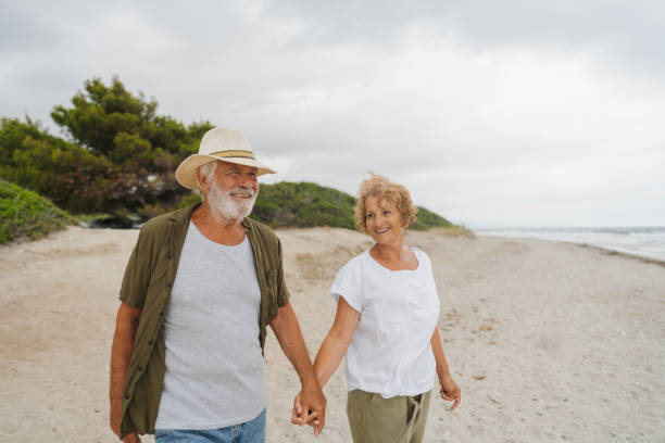 istock Senior couple in a romantic walk down the beach 1782255992