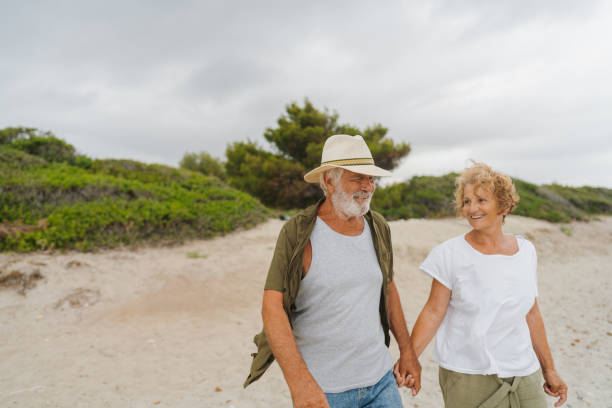 istock Senior couple in a romantic walk down the beach 1782256510