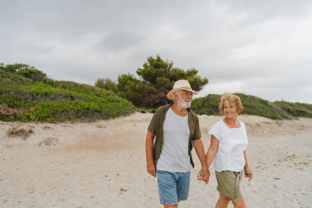 istock Senior couple in a romantic walk down the beach 1782256511