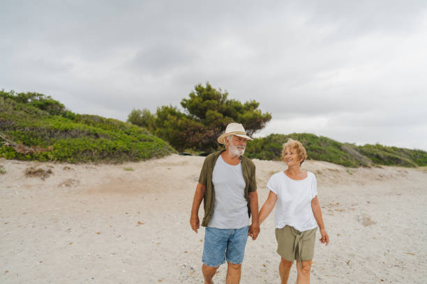 istock Senior couple in a romantic walk down the beach 1782256515
