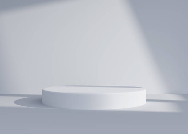istock Empty white round podium, pedestal or display in room with falling shadow from window. Realistic abstract interior space for fashion product presentation. Modern minimalistic 3d render. 1782304857