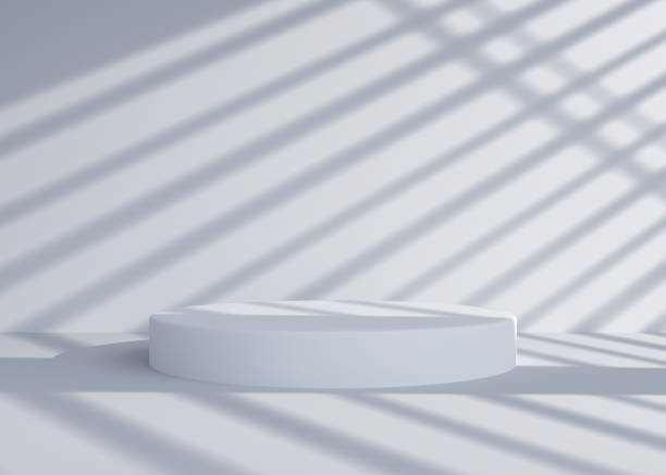 istock Empty white round podium, pedestal or display in room with falling shadow from window. Realistic abstract interior space for fashion product presentation. Modern minimalistic 3d render. 1782304867