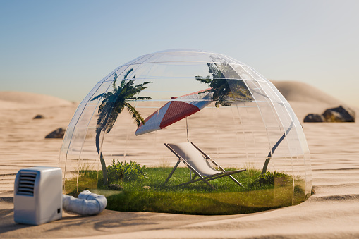 Holiday idyll sun lounger and parasol on a small grassy area under a glass dome in the middle of the desert; Air conditioning and global warming concept; 3D illustration