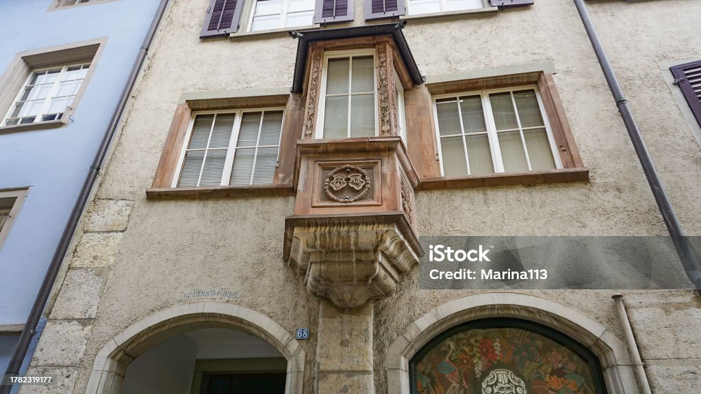 Schaffhausen, Switzerland - October 21, 2023: Beautiful facade of historic house at the old town of Swiss City of Schaffhausen on a foggy winter day. Schaffhausen, Switzerland - October 21, 2023: Beautiful facade of historic house at the old town of Swiss City of Schaffhausen on a foggy day at Schaffhausen, Switzerland on October 21, 2023 Ancient Stock Photo
