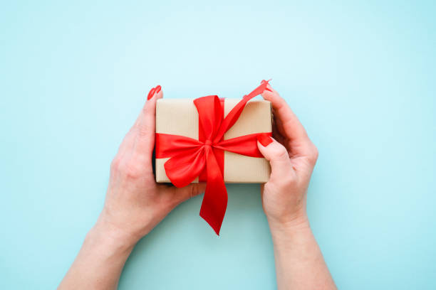 istock Boxing day, Christmas present. Woman giving Christmas present. 1782329897