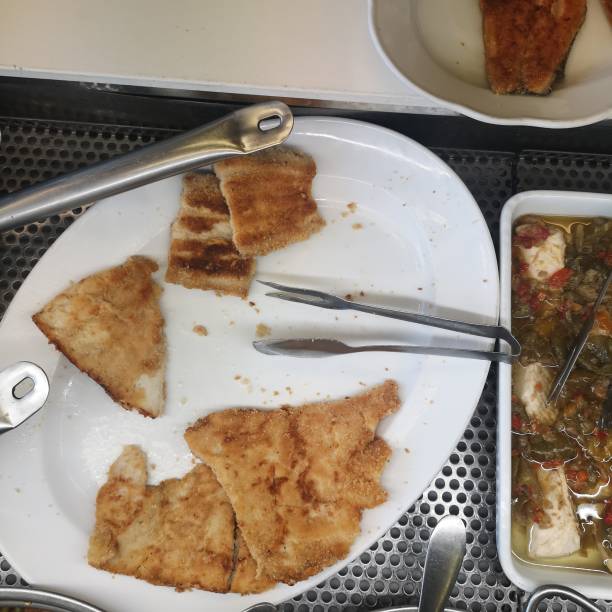 istock Breaded and fried sea bass fillet on a serving plate- 1782335292