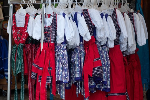 Traditional costumes in Bavaria: Dirndl, typical Alpine clothes for women, colorful selection in stores