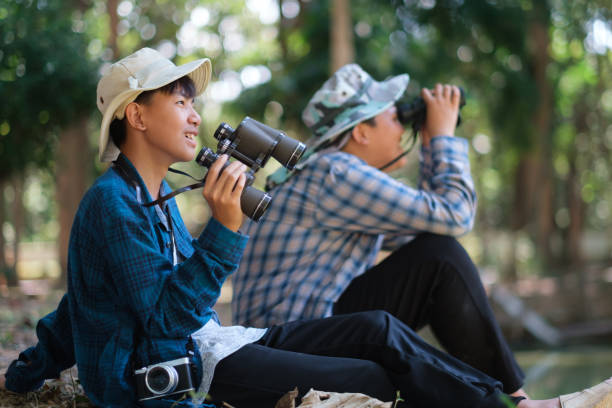 istock Two young boys exploring the forest hiking and camping, learning about the wildlife, using binoculars to search for animals with friends. Happy smiling excited summer vacation. 1782362625
