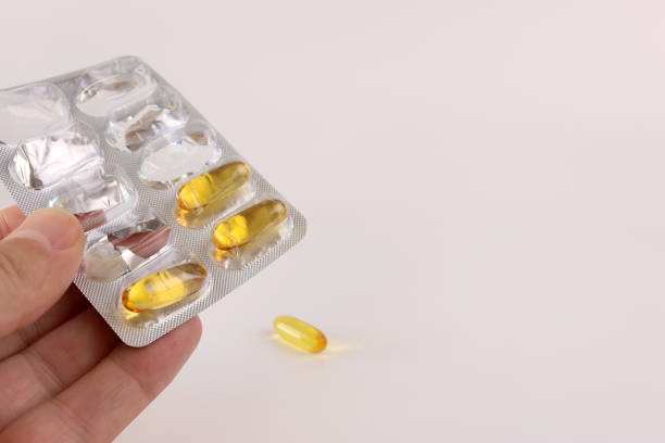 istock A man holds a polyunsaturated fatty acid complex capsule in his hand. Prevention and treatment of ischemic heart disease, atherosclerosis of cerebral vessels. 1782368868