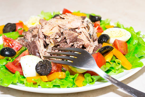 Tuna salad, olives, tomatoes, lettuce, eggs and olive oil