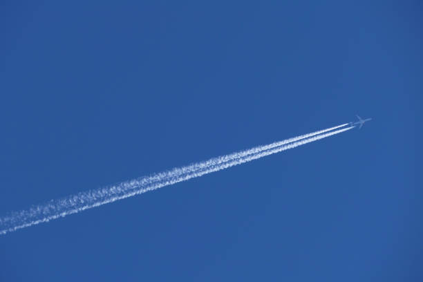 istock airplane in the blue sky, contrail 1782373292