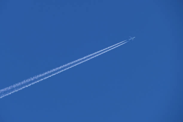 istock airplane in the blue sky, contrail 1782373342