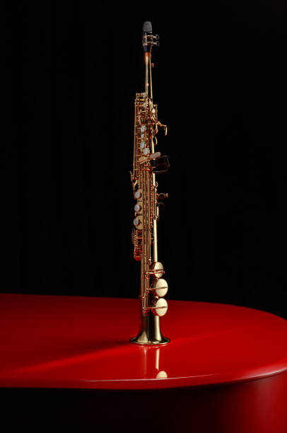 istock Straight form saxophone on the surface of a red piano. 1782399592