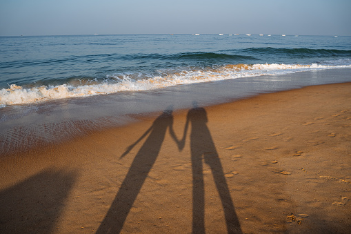 a couple on the beach with sunset. Walk along the seashore. outdoor recreation. High quality photo