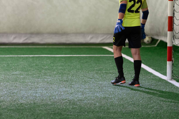 istock Futsal goalkeeper during the game. Indoor artificial grass five-a-side soccer match. 1782409035