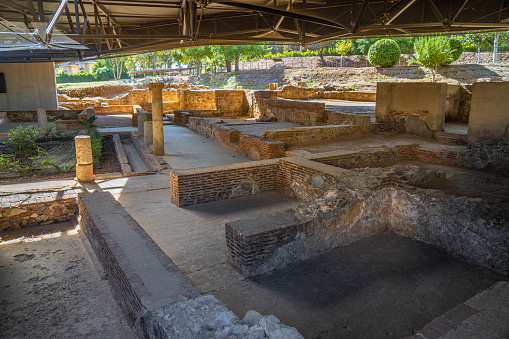 Historic Roman ruins of rooms with mosaic floors, brick walls and columns of the Merida archaeological complex of the Mithraeum house in Merida, Spain.