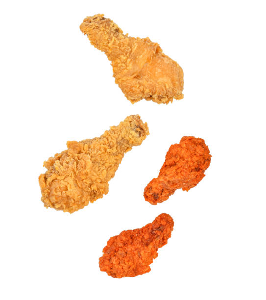 istock Fried chicken wings falling in the air isolated on white 1782410663