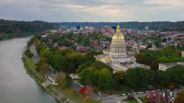 Static Aerial View of West Virginia State Capitol Building next to Kanawha River on Cloudy Day