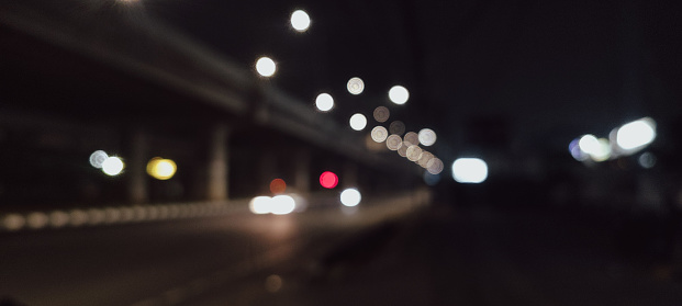 night atmosphere on the side of the road with a bokeh portrait style