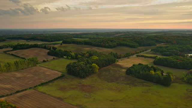 Leftward Orbiting Aerial Shot of Farmland near Shelby Village in Michigan in the Morning