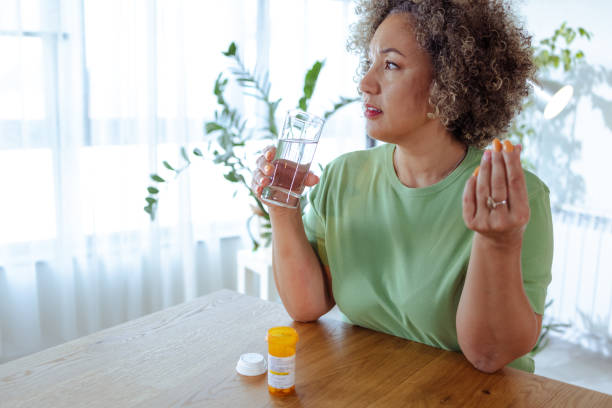istock Mature woman taking medicines at home 1782444745