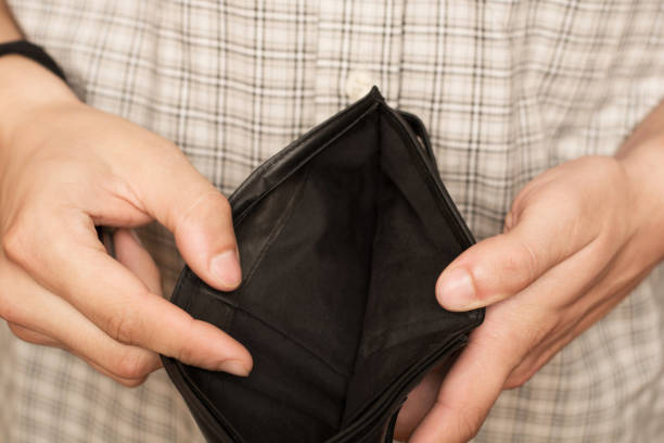 istock Close-up of hands opens an empty wallet. Shopping before Christmas. 1782445290
