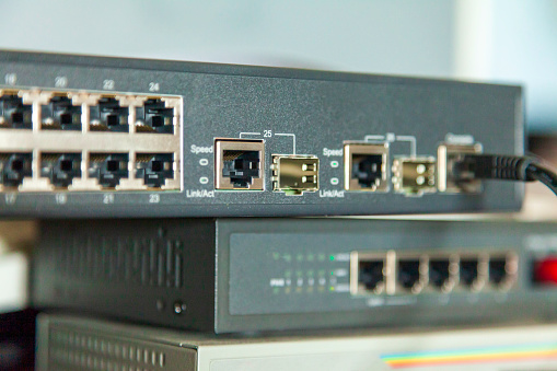 Network ethernet switches, patch cord connected to sfp port of network hardware. Concept of security of remote office work.