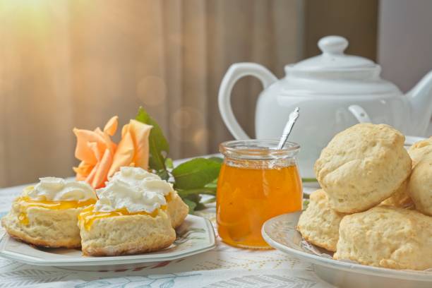 istock Scones with apricot jam and whipped cream on a table with jar of jam 1782462069