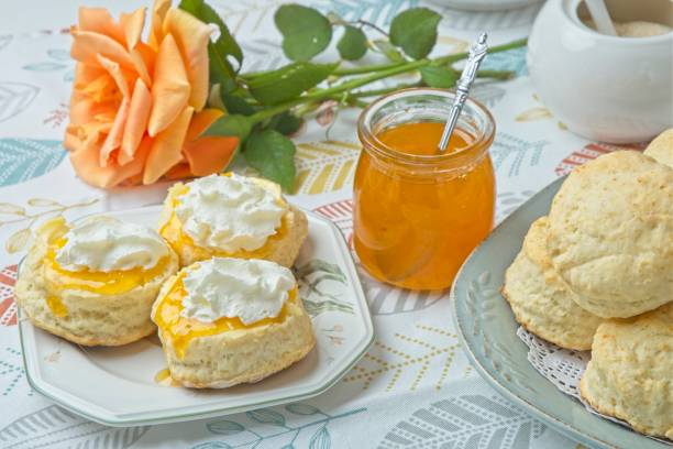 istock Scones with apricot jam and whipped cream on a table with jar of jam 1782462621