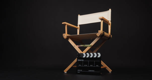 istock Clapper board with white director chair on black background. 1782465296