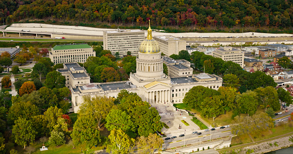 A high angle aerial still photo of the West Virginia State Capitol building on a cloudy day.