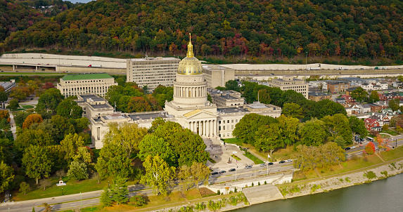 A high angle aerial still photo of the West Virginia State Capitol building on a cloudy day.