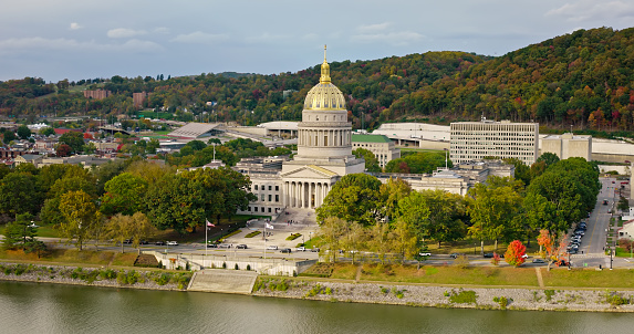 A high angle aerial still photo of the West Virginia State Capitol building on a cloudy day.