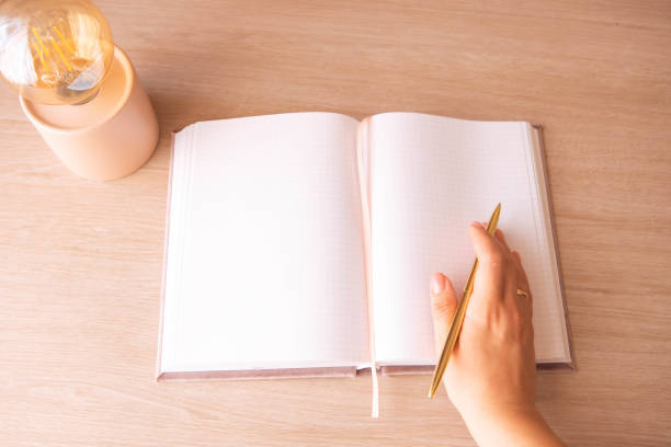 istock female hand holding a pen on a notepad 1782520863