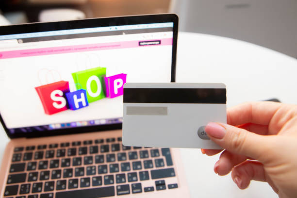istock female hand holds a black plastic bank card 1782520886