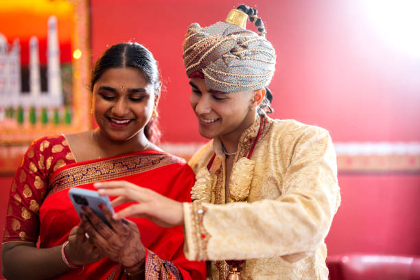 istock young indian couple sharing time together with mobile 1782523621