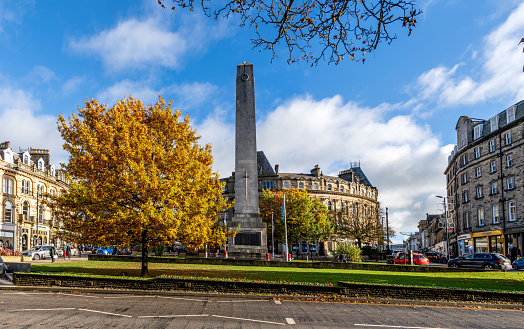 Harrogate, UK - November 7, 2023.  Landscape panorama of The Cenotaph and War Memorial remembering the fallen soldiers of World War at Prospect Square in Harrogate town centre in Autumn sunshine