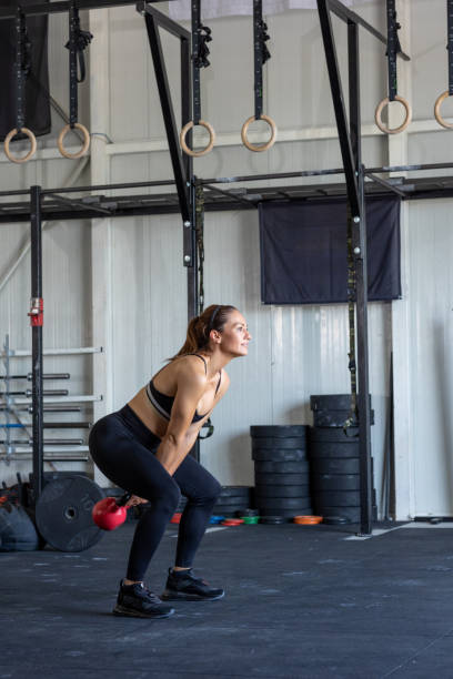 istock Woman doing kettlebell exercises in the gym 1782528342