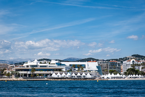 Cannes, France - May 4, 2023: The Palais des Festivals et des Congrès along the coast of Cannes viewed from the water. The convention center is the venue for the Cannes Film Festival.
