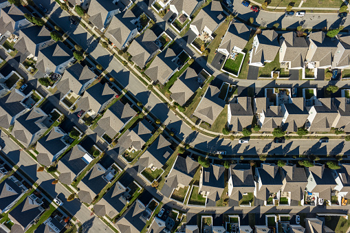 Aerial still image of a residential district with numerous cookie-cutter houses, taken by a drone on a sunny Fall day in Grove City, Ohio.