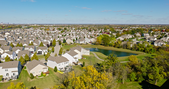 Aerial still image of a residential district with numerous cookie-cutter houses, taken by a drone on a sunny Fall day in Grove City, Ohio.