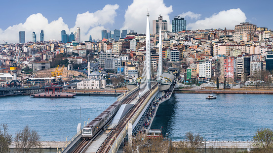 Istanbul, Turkey - March 2018: Panoramic view of Golden Horn Halic Metro Bridge in Istanbul, Turkey. It is a cable stayed bridge carrying the M2 line of the Istanbul Metro across the Golden Horn