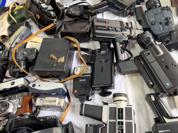 Istanbul, Turkey - June 2022: Mix of vintage old cameras and video recorders scattered on a desk